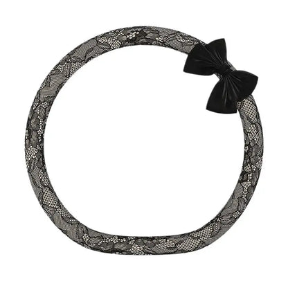 Onyx tweed lace steering wheel cover with black bow knot, D shape flat bottom, alternate angle