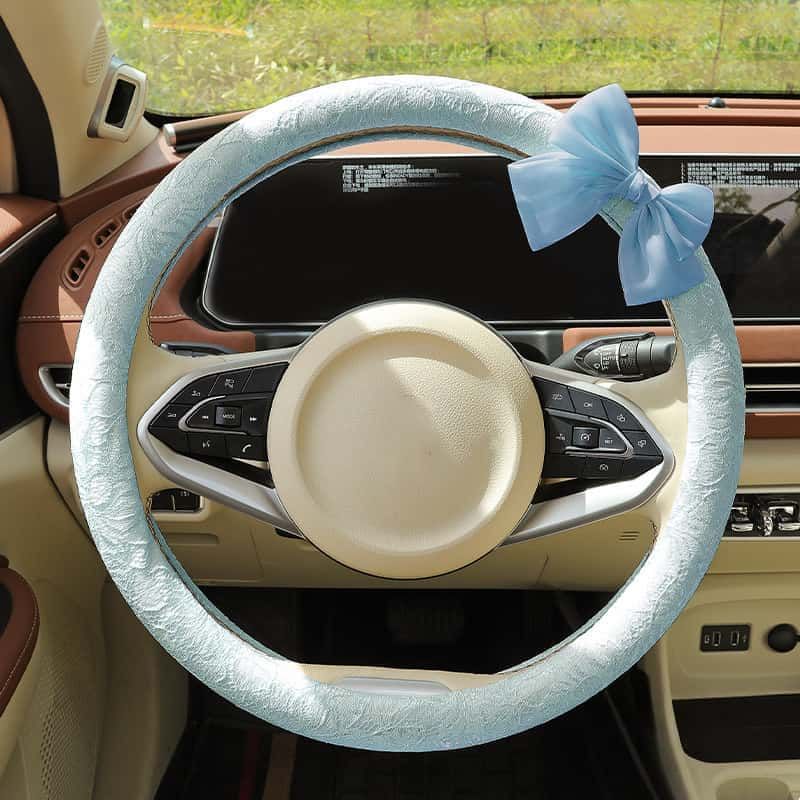 Baby blue lace steering wheel cover with bow installed in car interior