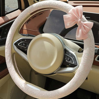 Blush pink lace steering wheel cover with bow installed on car steering wheel