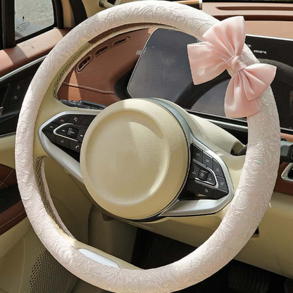 Blush pink lace steering wheel cover with bow installed on car steering wheel