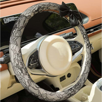 Black lace steering wheel cover with bow installed in car interior